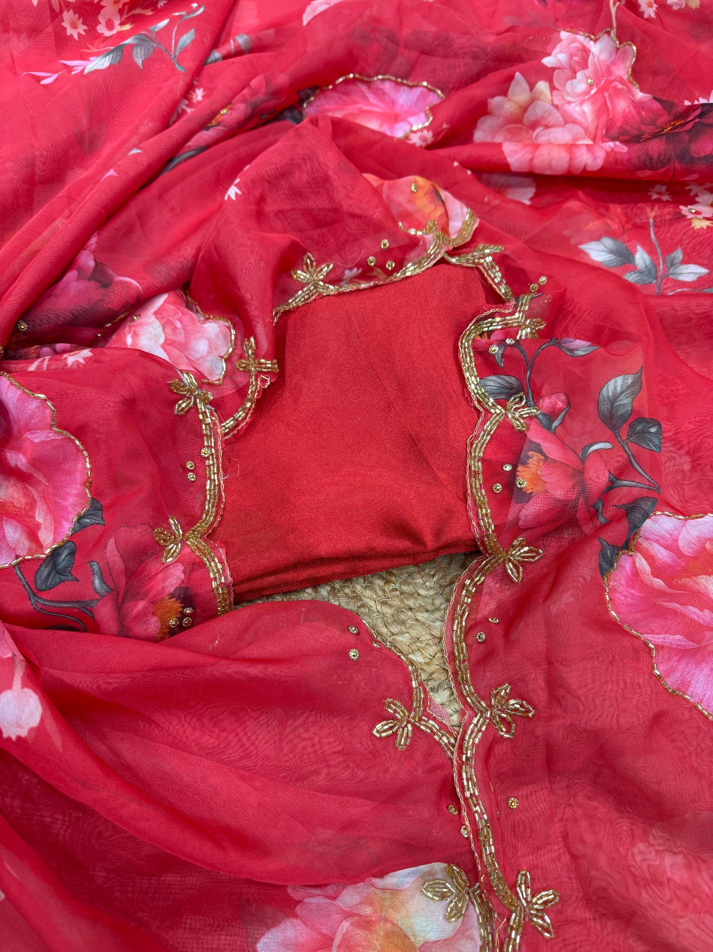 Exuding grace and sophistication, this floral-printed organza saree blends classic beauty with modern elegance