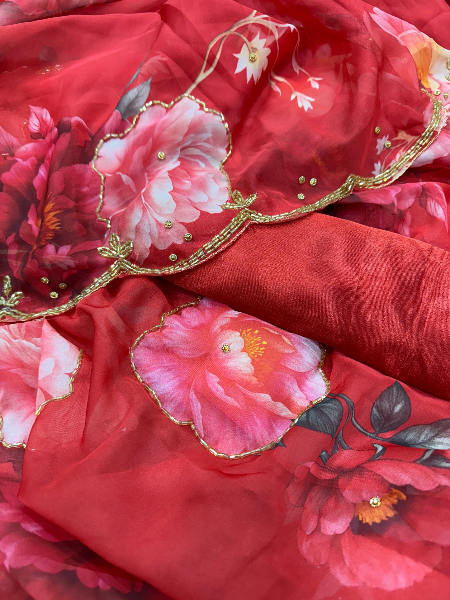 Exuding grace and sophistication, this floral-printed organza saree blends classic beauty with modern elegance