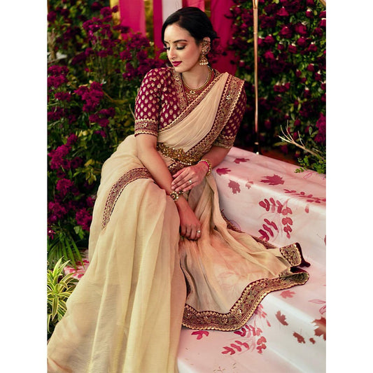 😍Unveil your inner fashionista with our stunning muted Champaign gold designer saree paired with the most sought-after Embroidery blouse in rich red.