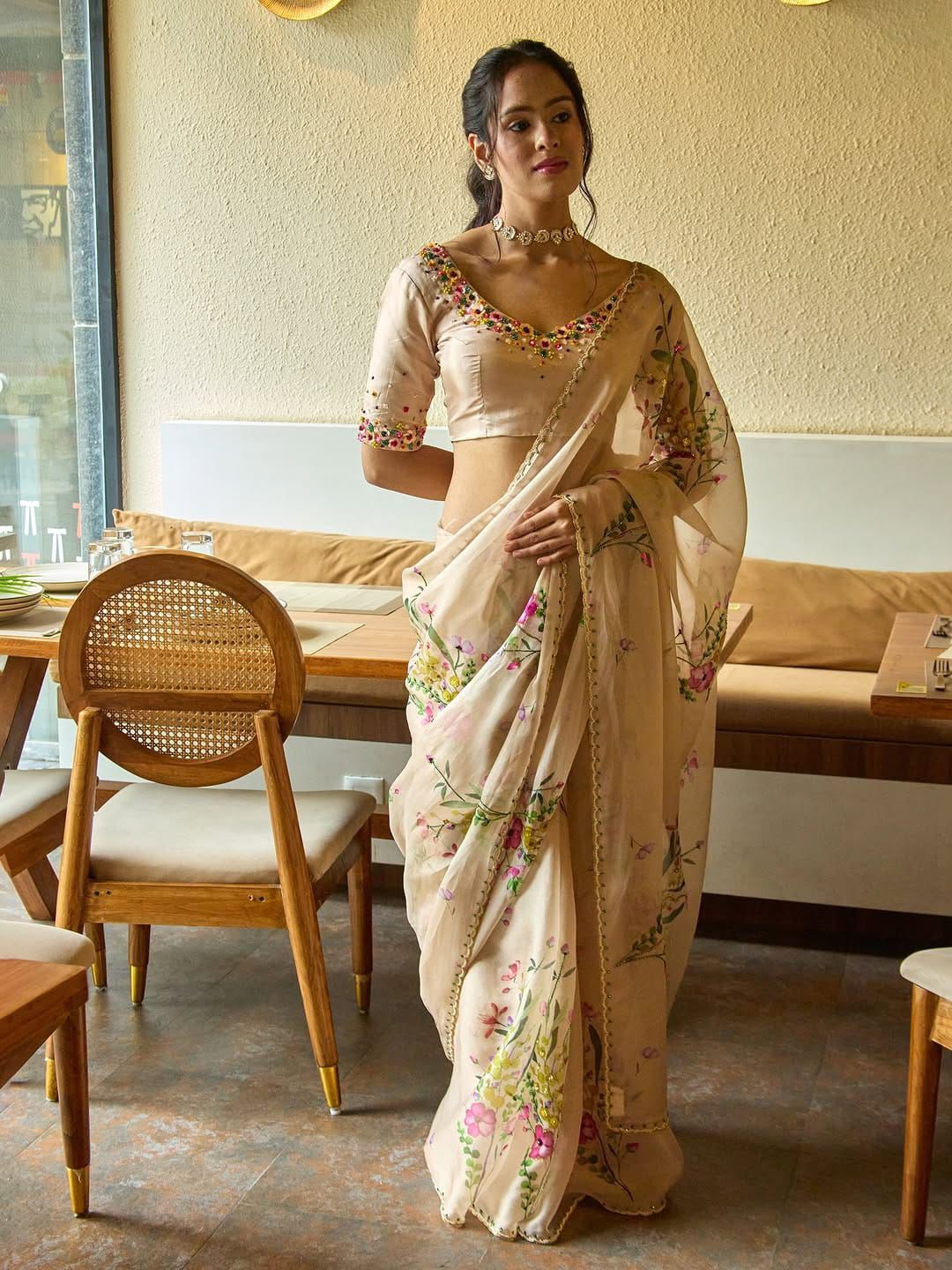 Exuding grace and sophistication, this floral-printed organza saree blends classic beauty with modern elegance.
