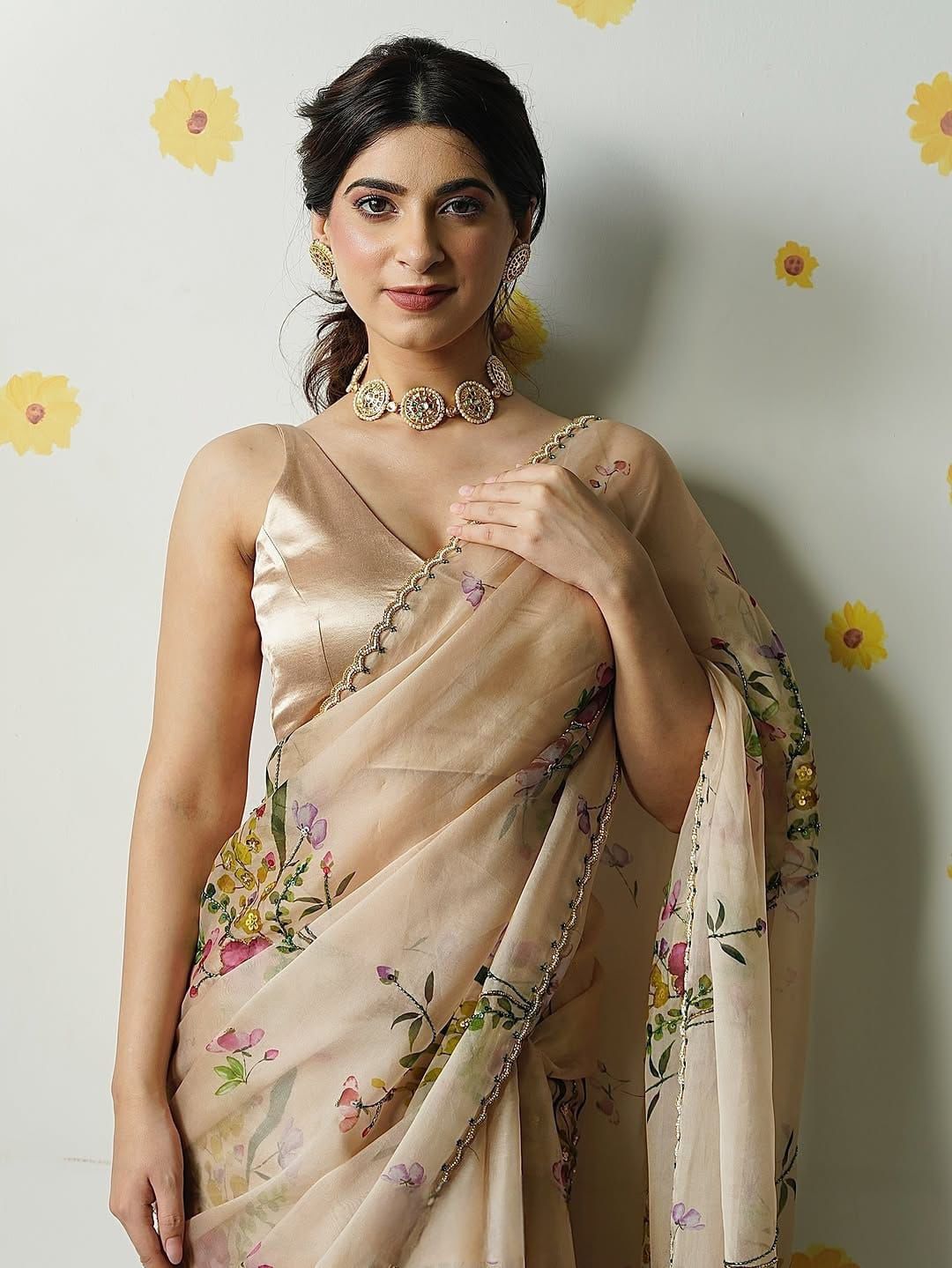 Exuding grace and sophistication, this floral-printed organza saree blends classic beauty with modern elegance.