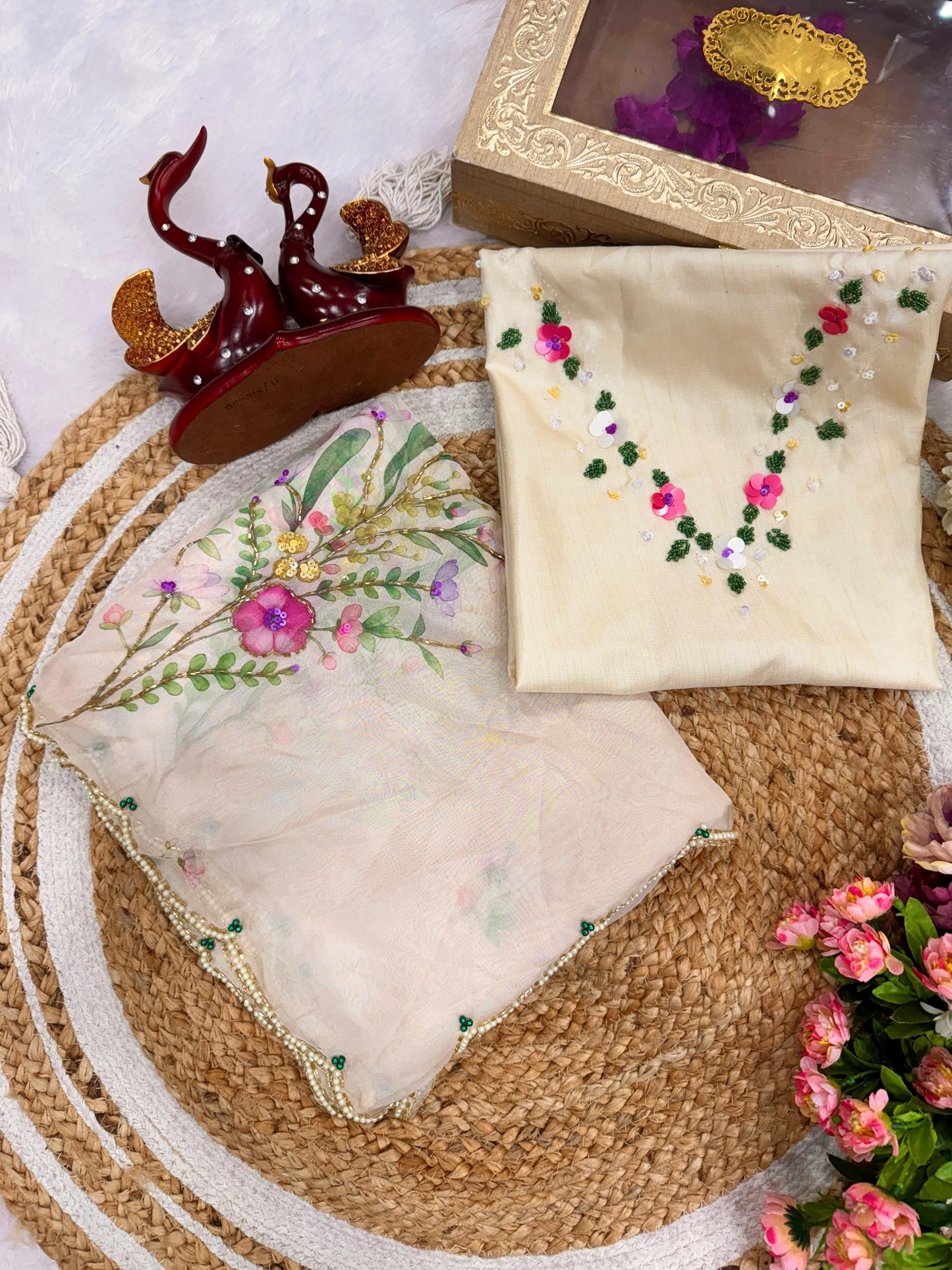 Exuding grace and sophistication, this floral-printed organza saree blends classic beauty with modern elegance.