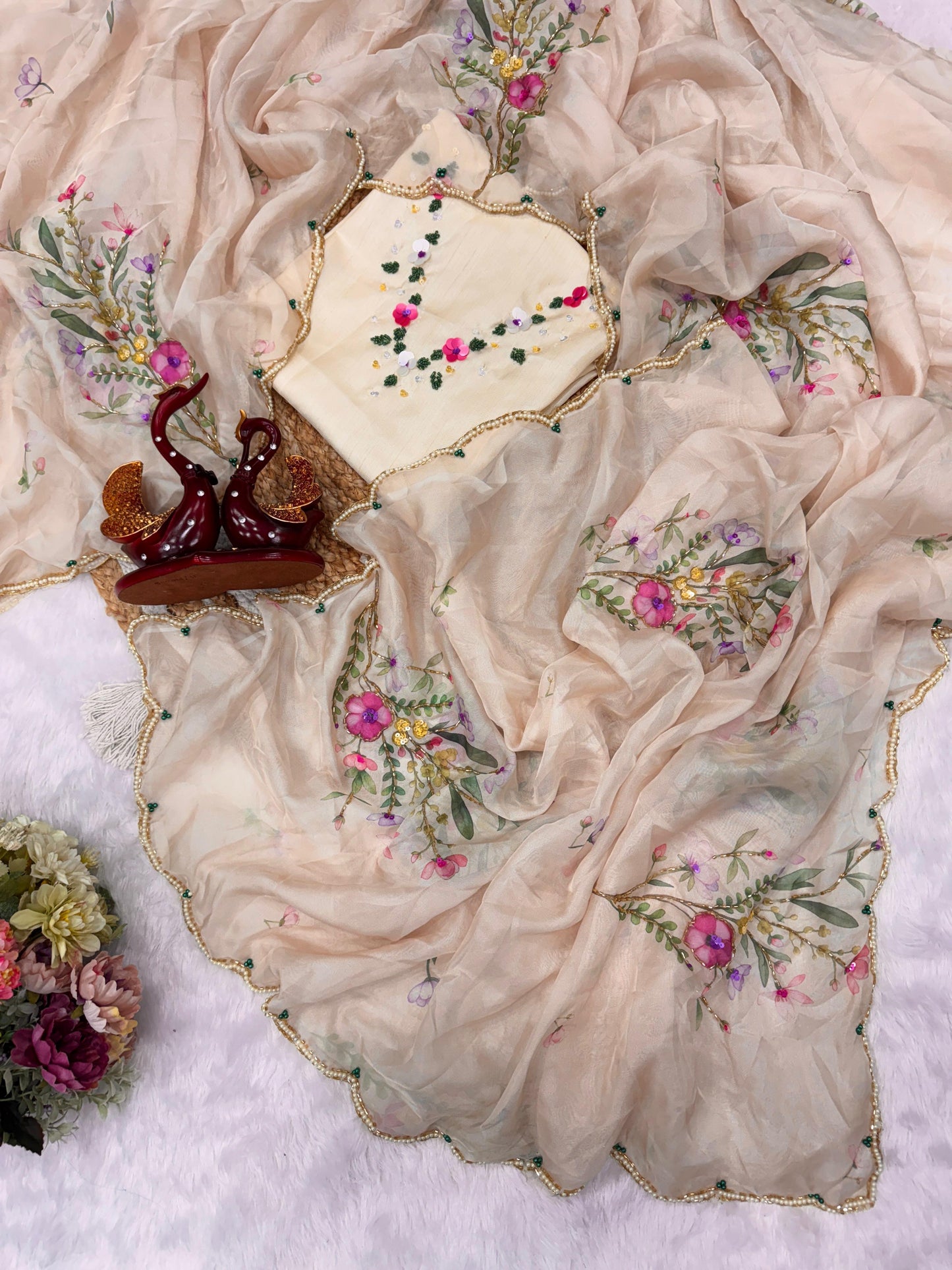 Exuding grace and sophistication, this floral-printed organza saree blends classic beauty with modern elegance.