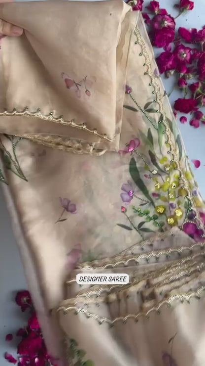Exuding grace and sophistication, this floral-printed organza saree blends classic beauty with modern elegance.
